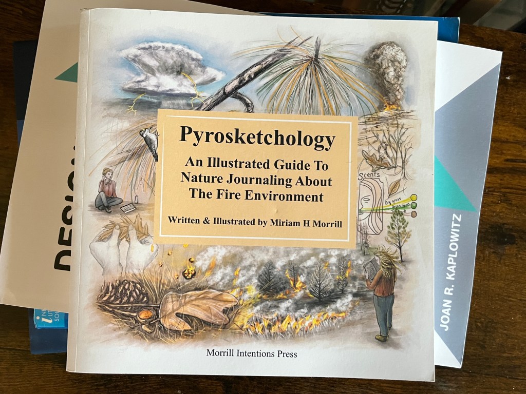 Photo of a book titled "Pyrosketchology: An Illustrated Guide to Nature Journaling about The Fire Environment," by Miriam H. Morrill.